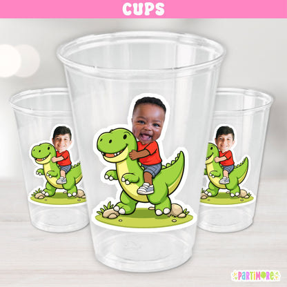 Set of 12 personalized 16 oz dinosaur birthday cups featuring a custom child photo riding a green dinosaur for kids dino parties